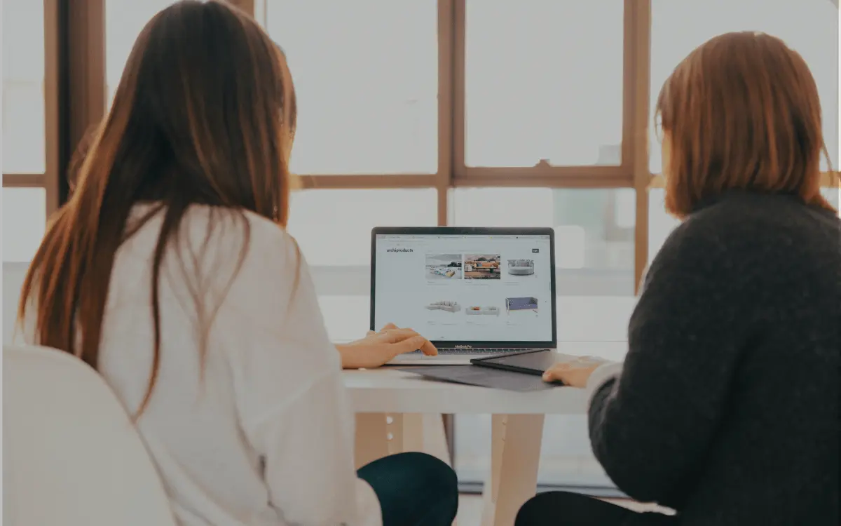 Two people reviewing options together on a laptop